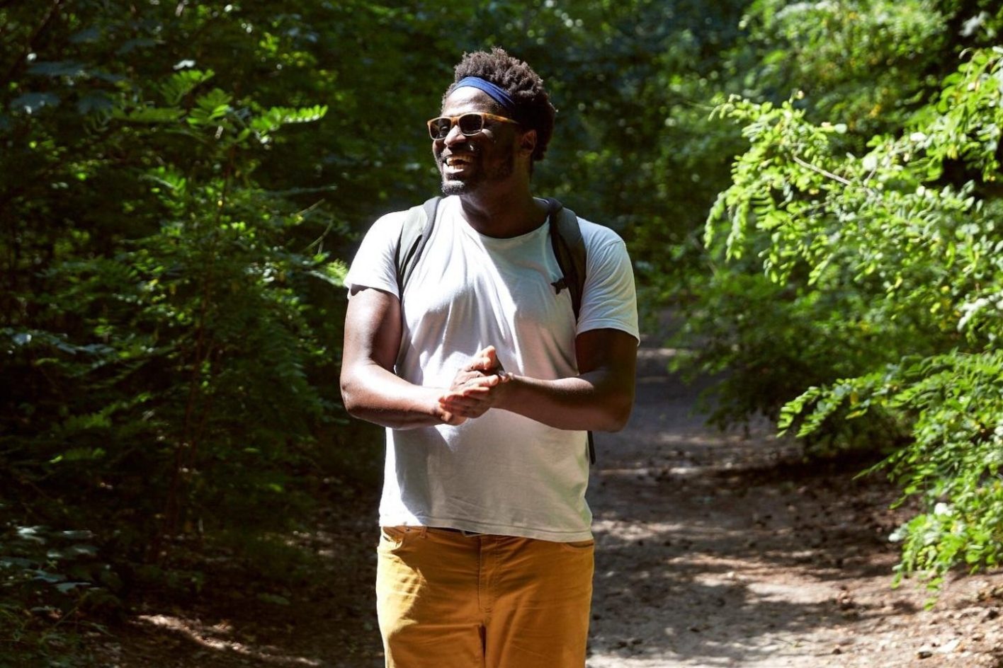 Anthony Owosekun pictured in a sunny forest. Anthony is the CEO and founder of the charity EMPOCA.